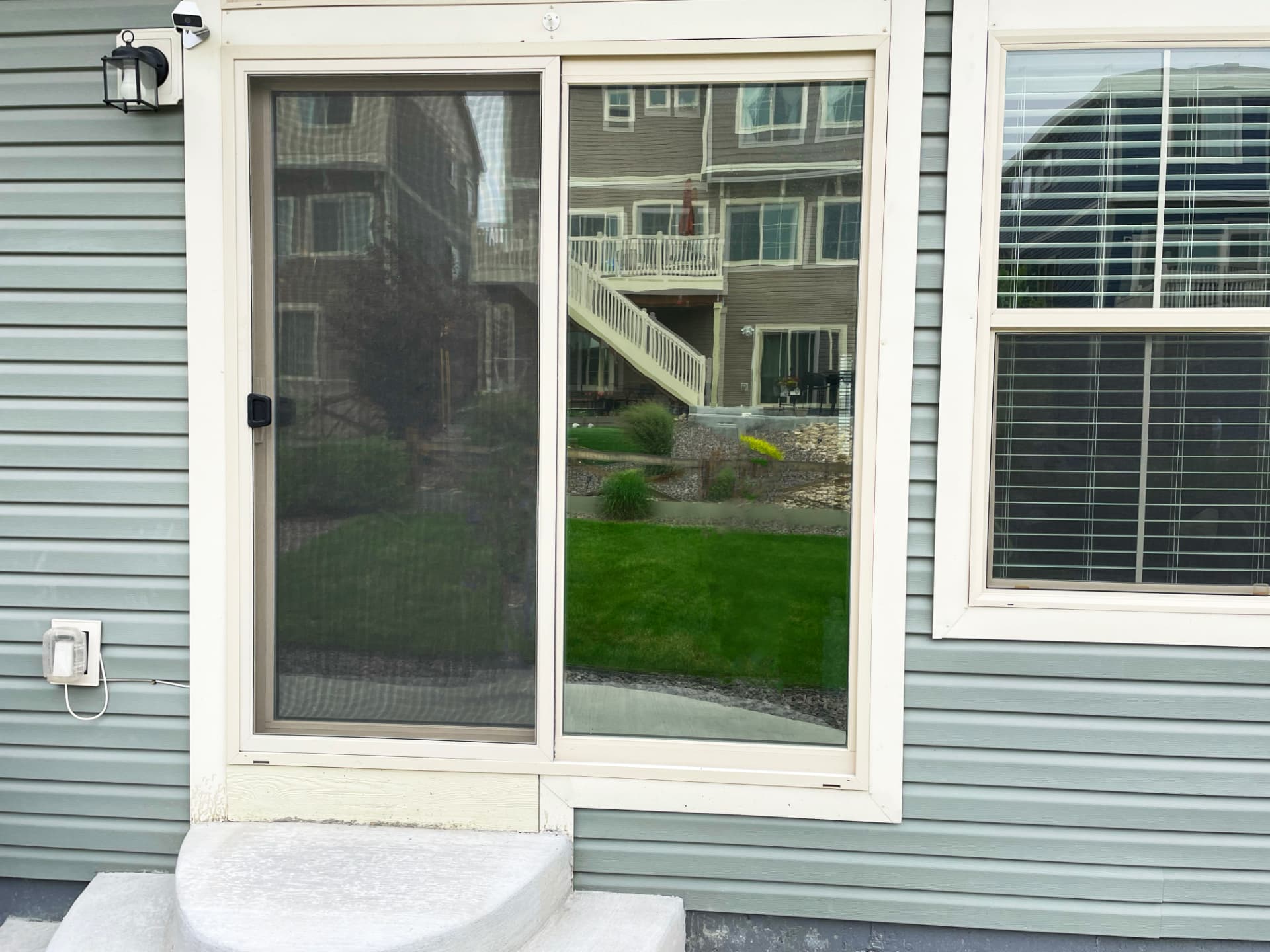 Tinted sliding glass door and window on a home exterior
