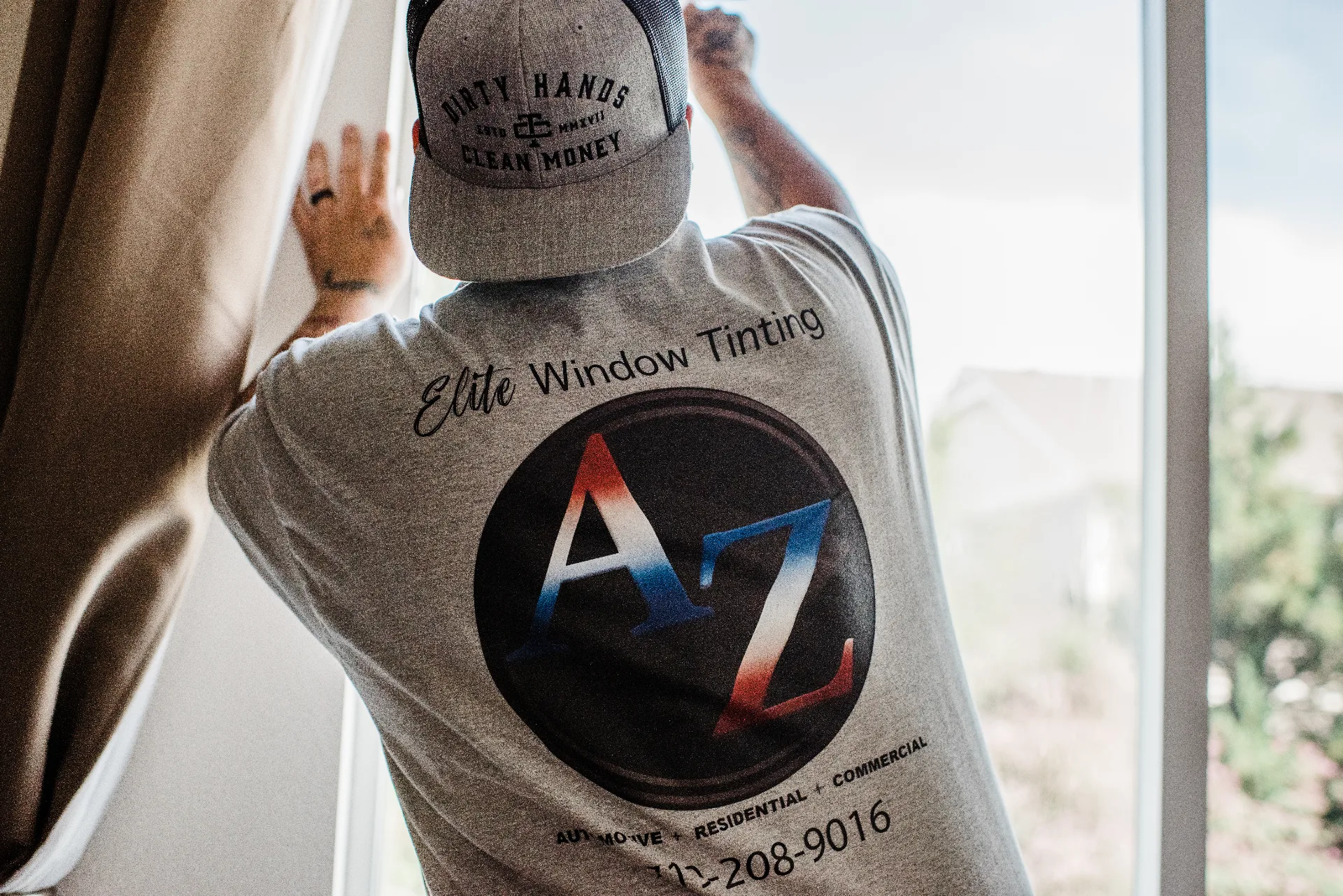 Installer prepping a residential window before applying film