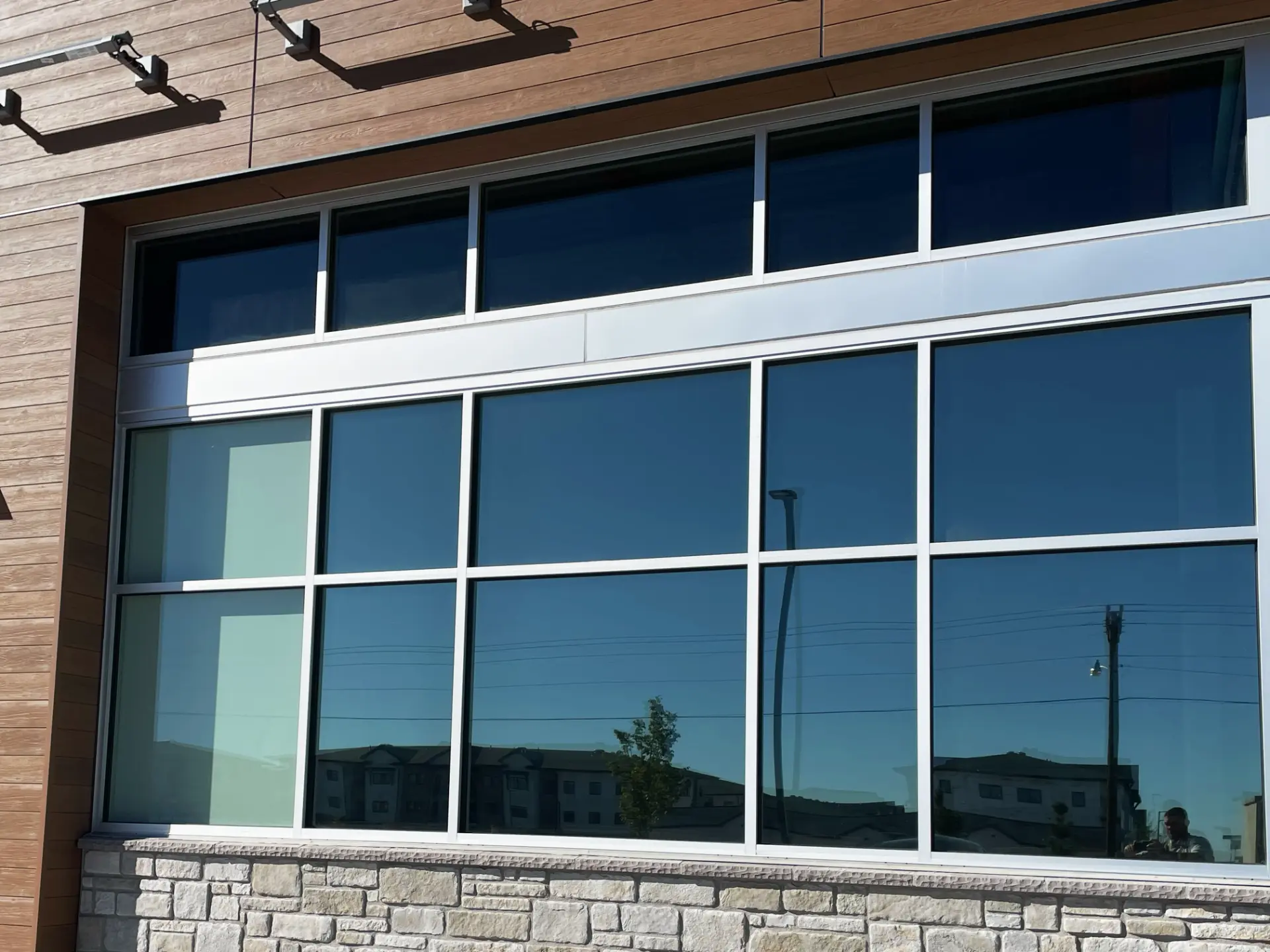 Dark tinted commercial window wall on a modern building