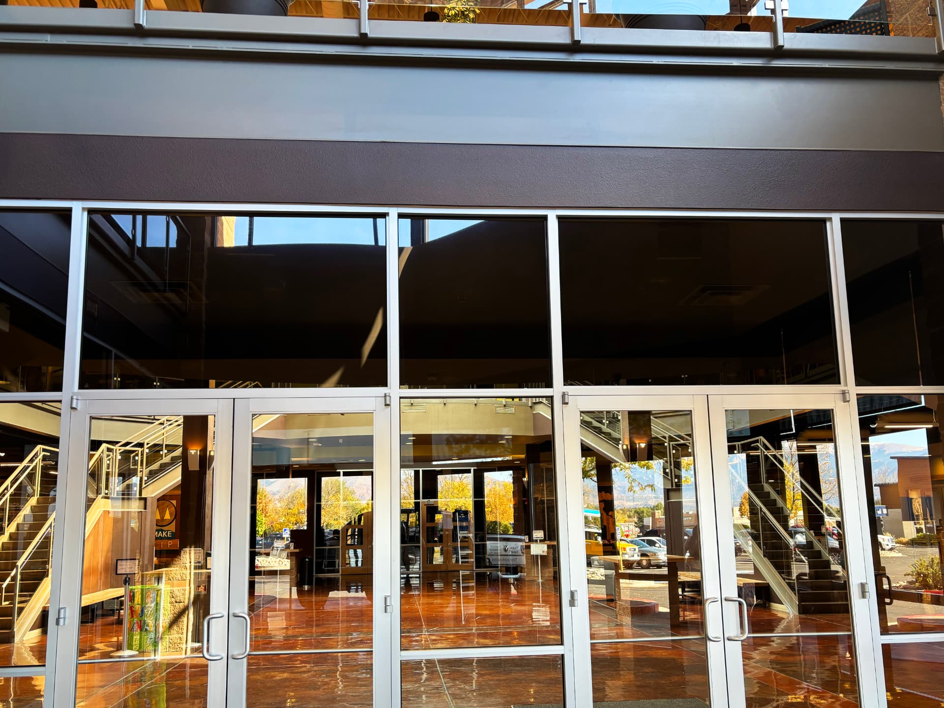 Large tinted glass entrance of a commercial lobby