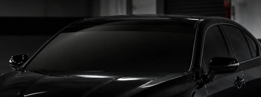 Sun strip tint applied along the top of a car windshield